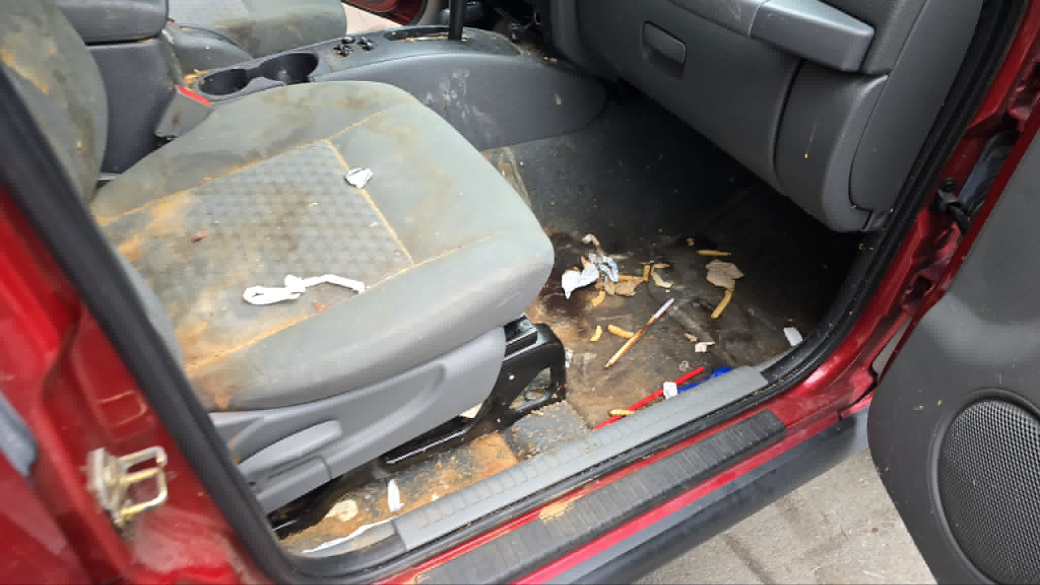 Open door showing debris through the cabin